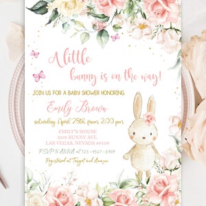 May include: A pink and gold baby shower invitation with a watercolor floral design and a cute bunny illustration. The text reads "A little bunny is on the way!" and includes the name "Emily Brown" and details for the event.