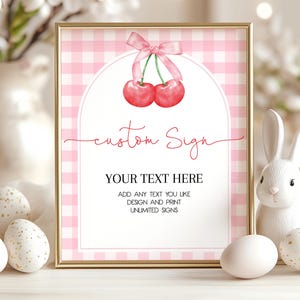 May include: A printable sign with a pink and white gingham background. The sign features a watercolor illustration of two red cherries with a pink ribbon. The text on the sign reads "custom Sign" and "YOUR TEXT HERE". The text below the cherries reads "ADD ANY TEXT YOU LIKE DESIGN AND PRINT UNLIMITED SIGNS".