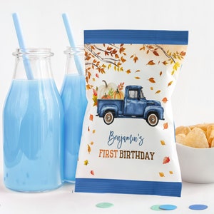 May include: Blue and white personalized chip bag with a blue truck carrying pumpkins and fall leaves. The bag says "Benjamin's First Birthday".