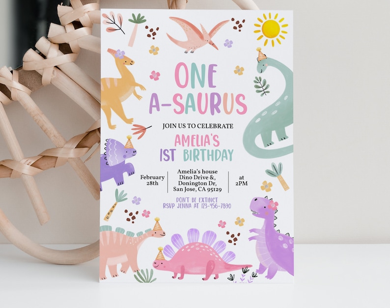 May include: A pink and purple dinosaur birthday party invitation with the text "One A-saurus" and "Amelia's 1st Birthday". The invitation features a variety of dinosaurs, flowers, and a sun.