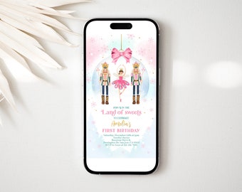 May include: A digital invitation for a first birthday party with a Nutcracker theme. The invitation features a ballerina doll dancing with a Nutcracker soldier in front of a pink and blue ornament. The text reads "Join us in the Land of Sweets to celebrate Amelia's First Birthday".