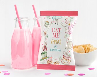 May include: A pink and white chip bag with an Alice in Wonderland theme. The bag has a gold frame with the text "Eat Me Emma's 1st Birthday".