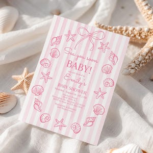 May include: A pink and white striped baby shower invitation with seashell and starfish illustrations. The invitation reads "Sea you soon BABY!" and includes details for Emily's baby shower.
