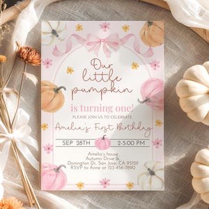 May include: A pink and white invitation card with watercolor pumpkins and floral accents. The text reads "Our little pumpkin is turning one!" and includes the date, time, and location for Amelia's first birthday celebration.