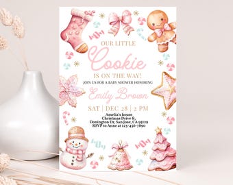 May include: A pink and gold baby shower invitation with a watercolor illustration of a gingerbread cookie, a snowman, a Christmas tree, and a candy cane. The text reads "Our Little Cookie is on the Way!" and includes the date, time, and location of the event.