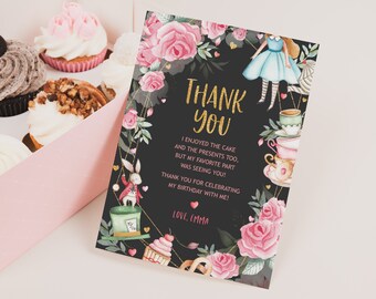 May include: A black thank you card with gold glitter text that says "Thank You". The card is decorated with pink roses, green leaves, and a watercolor illustration of Alice in Wonderland characters. The text reads "I enjoyed the cake and the presents too, but my favorite part was seeing you! Thank you for celebrating my birthday with me! Love, Emma."