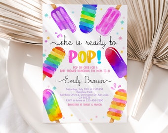 Puede incluir: Una invitación para baby shower con paletas de acuarela coloridas. El texto dice "she is ready to POP!" con detalles del evento y el nombre de la futura madre. El diseño incluye colores pastel y acentos de estrellas.