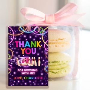 May include: A purple thank you tag with neon green and pink circles and stars. The tag says "Thank You" in rainbow letters and "For bowling with me! Love, Charlotte".