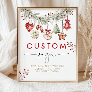 Puede incluir: Un letrero enmarcado con un borde dorado presenta las palabras "CUSTOM sign" en escritura roja. El letrero está decorado con ilustraciones de acuarela de galletas navideñas y vegetación. El texto en la parte inferior dice "ADD ANY TEXT YOU LIKE DESIGN AND PRINT UNLIMITED SIGNS."
