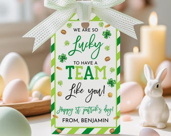 May include: A St. Patrick's Day gift tag with a green and white striped border and a light green bow. The tag reads "We are so lucky to have a team like you! Happy St. Patrick's Day! From, Benjamin."