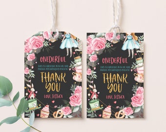 May include: Two black and white thank you tags with a floral design and Alice in Wonderland characters. The text reads "ONEDERFUL for celebrating with me and making my birthday magical! Thank you Love, Jessica".
