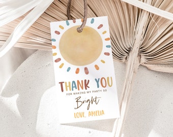 May include: A thank you tag with a watercolor sun design in shades of orange, yellow, red, blue, and green. The text reads "Thank You for making my party so Bright Love, Amelia".