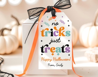 May include: A white gift box with a black bow and orange ribbon. A tag reads "no tricks just treats" with colorful text and candy illustrations. The tag also says "Happy Halloween!" and "From, Emily". White pumpkins are in the background.