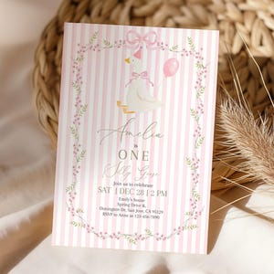May include: A pink and white striped invitation card with a cartoon goose wearing a party hat and holding a pink balloon. The text reads "Amelia is ONE Olly Goose" with event details and RSVP information.
