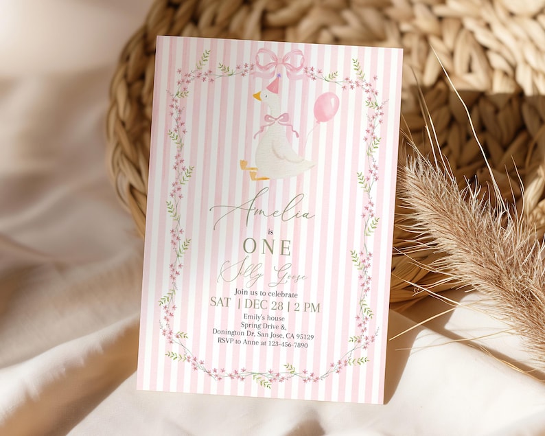 May include: A pink and white striped invitation card with a cartoon goose wearing a party hat and holding a pink balloon. The text reads "Amelia is ONE Olly Goose" with event details and RSVP information.