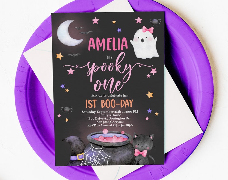 May include: A black and white invitation with a pink and purple ghost, a black cat, and a cauldron. The text reads "Amelia is a spooky one. Join us to celebrate her 1st Boo-Day. Saturday, September 28th at 2:00 PM. Emily's House. Boo Drive & Donington Dr, San Jose, CA 95129. RSVP to Anne at 123-456-7890."