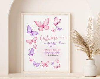May include: A printable sign with a watercolor design of pink and purple butterflies. The text on the sign reads "Custom sign" and "Add any text you like Design and print Unlimited signs".