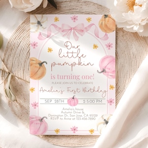 May include: A pink and white birthday invitation with watercolor pumpkins, flowers, and a bow. The text reads "Our little pumpkin is turning one!" and includes the date, time, and location for Amelia's first birthday.