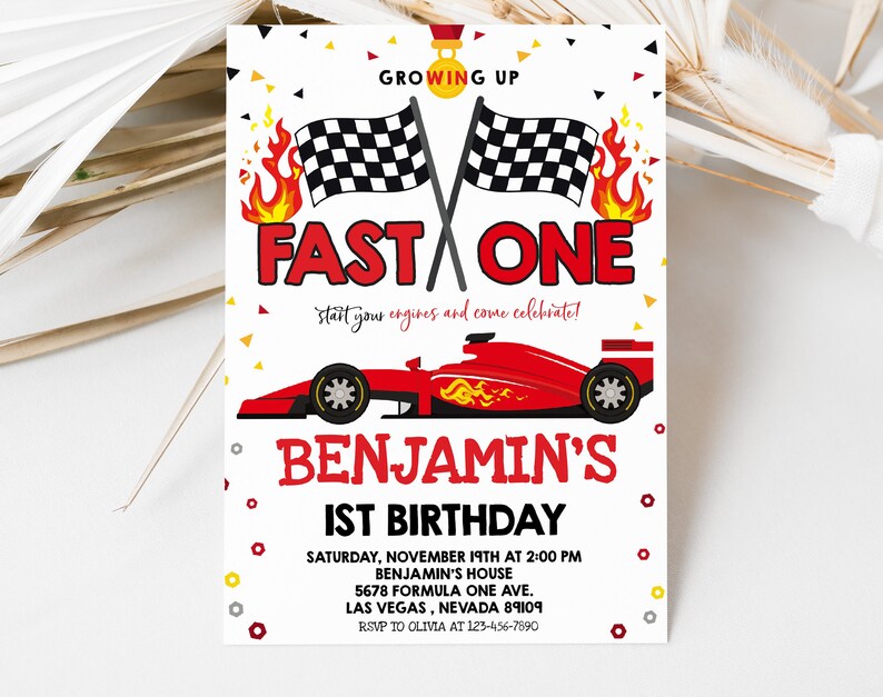 May include: A red, white and black birthday invitation featuring a red racing car and chequered flags. The text reads "Growing Up Fast One, start your engines and come celebrate! Benjamin's 1st Birthday. Saturday, November 19th at 2:00 PM, Benjamin's House, 5678 Formula One Ave., Las Vegas, Nevada 89109, RSVP to Olivia at 123-456-7890."
