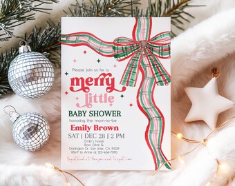 May include: A baby shower invitation with a festive design. The invitation features a red and green ribbon, the words "merry little BABY SHOWER", and details for Emily Brown's shower on December 28th at 2 PM. Silver disco ball ornaments and a white star are also visible.