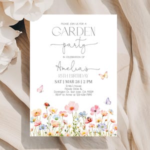 以下が含まれることがあります： 「GARDEN party」と「Amelia's 18TH BIRTHDAY」の文字が入った白い招待状。ピンク、青、黄色の水彩画の花と蝶が描かれています。日付と時間も記載されています。