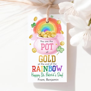 May include: A white St. Patrick's Day gift tag featuring a rainbow, pot of gold, and shamrock. The tag says "You are the POT of GOLD at the end of the RAINBOW Happy St. Patrick's Day! From, Benjamin."