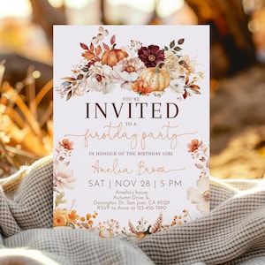 May include: A rectangular invitation card with the text "YOU'RE INVITED to a firstday party" in brown and white. The card features floral and pumpkin illustrations in shades of orange, white, and burgundy. The name "Amelia Brown" is also included.