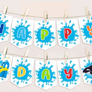 May include: A white banner with blue water splatter designs and colourful letters spelling "HAPPY DAY" with a blue and yellow inflatable slide and ice cream cones on the left and a black and white orca whale on the right.