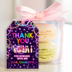 May include: A purple thank you tag with neon pink, green, blue, and yellow circles and stars. The tag says "Thank You" in rainbow letters and "For bowling with me! Love, Charlotte". There is a cartoon bowling ball and pins in the center of the tag.