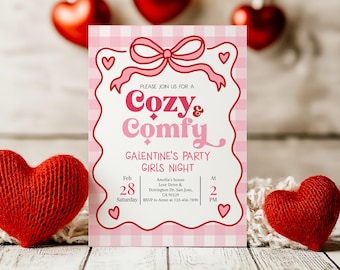 May include: A pink and white invitation for a Galentine's Girls Night. The invitation features the words "Cozy & Comfy" in a decorative font, with a pink bow and hearts. The date is February 28th at 2 PM.