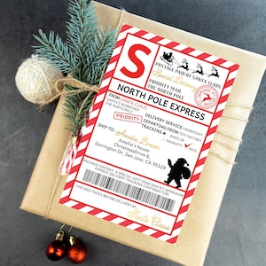 May include: A wrapped gift with a red and white "North Pole Express" label. The label includes text such as "Priority Mail" and "Santa Claus." The gift is decorated with a sprig of evergreen, a twine bow, and Christmas baubles.