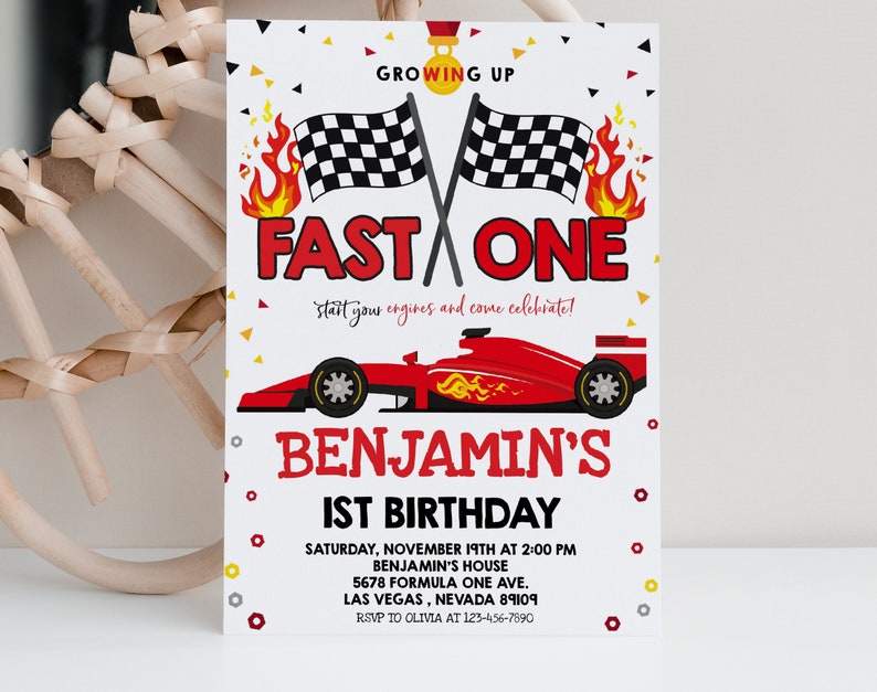 May include: A red, white and black birthday invitation featuring a red racing car and chequered flags. The text reads "Growing Up Fast One, start your engines and come celebrate! Benjamin's 1st Birthday. Saturday, November 19th at 2:00 PM, Benjamin's House, 5678 Formula One Ave., Las Vegas, Nevada 89109, RSVP to Olivia at 123-456-7890."