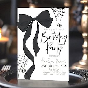 May include: A black and white birthday party invitation with a large bow, spiderwebs, and a spider graphic. The invitation reads "Please join us for a Birthday Party" and includes the honoree's name, date, time, and location.