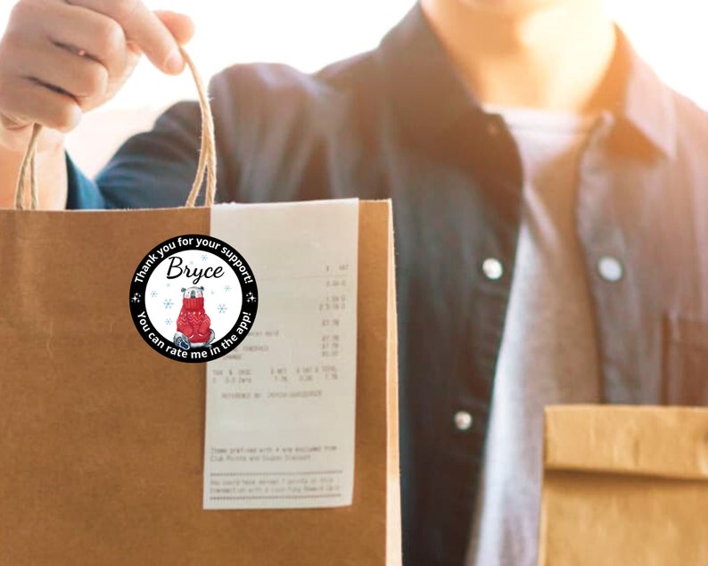 May include: A brown paper shopping bag with a round sticker that says "Thank you for your support! Bryce. You can rate me in the app!" The sticker has a red bear design.