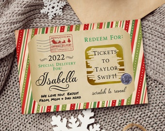 May include: A Christmas-themed gift card with red and green stripes. The card has a scratch-off area that says "Redeem For: Tickets to Taylor Swift!" and a message that says "2022 Special Delivery For: Isabella We love you! Enjoy! From, Mom + Dad xoxo".