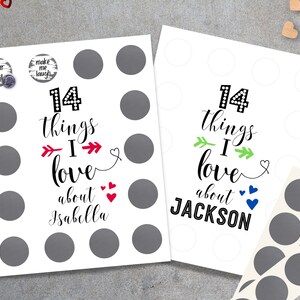 May include: Two white cards with black text that reads "14 things I love about Isabella" and "14 things I love about JACKSON". Each card has 14 gray circles for stickers. There are two small round stickers that say "Your Smile" and "Make Me Laugh".