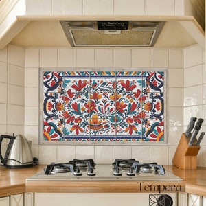 May include: A kitchen backsplash featuring a colourful floral tile design. The tile is a mix of red, orange, yellow, blue, and green. The tile is set against a white background. The tile is labelled "Tempera Ceramic".