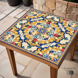 Könnte beinhalten: Quadratischer Beistelltisch aus Holz mit gefliester Oberfläche, die ein farbenfrohes Blumenmuster in Rot, Blau, Gelb und Creme zeigt. Der Tisch hat vier Holzbeine und eine dekorative Umrandung. Maße ca. 60 cm x 60 cm.