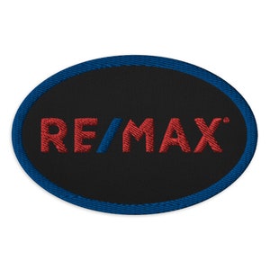 May include: A black oval patch with a blue border and the red text "RE/MAX" in the center.