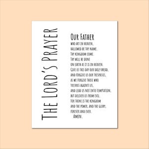 May include: A white rectangular print featuring the text of The Lord's Prayer in black. The words "THE LORD'S PRAYER" are printed vertically on the left side. The prayer begins with "Our Father" and ends with "Amen."