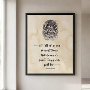 May include: A framed print with a black border, featuring a quote by Mother Teresa. The quote, in elegant script, reads "Not all of us can do great things, but we can do small things with great love." An illustration of birds and flowers is at the top.