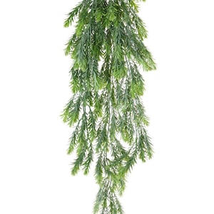 May include: A long, green, artificial hanging plant with many branches and leaves.