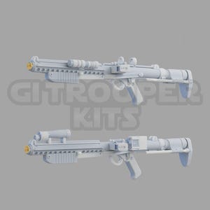 May include: Two white plastic toy blasters with a gold accent on the front. The blasters have a futuristic design with a scope on top and a handle on the bottom.