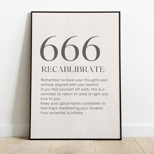 May include: A black framed poster with the number 666 and the word "Recalibriate" in grey text. The poster includes a motivational quote about aligning thoughts and actions with beliefs.