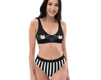 May include: Black and white striped high-waisted bikini bottom with a black bikini top featuring a white bat graphic.