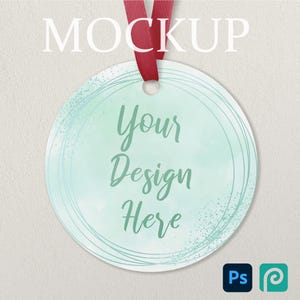 May include: A round ornament with a watercolor-style design in shades of teal and green, featuring the text "Your Design Here." It hangs from a red ribbon. The word "MOCKUP" is at the top. The Adobe Photoshop and Procreate logos are at the bottom.