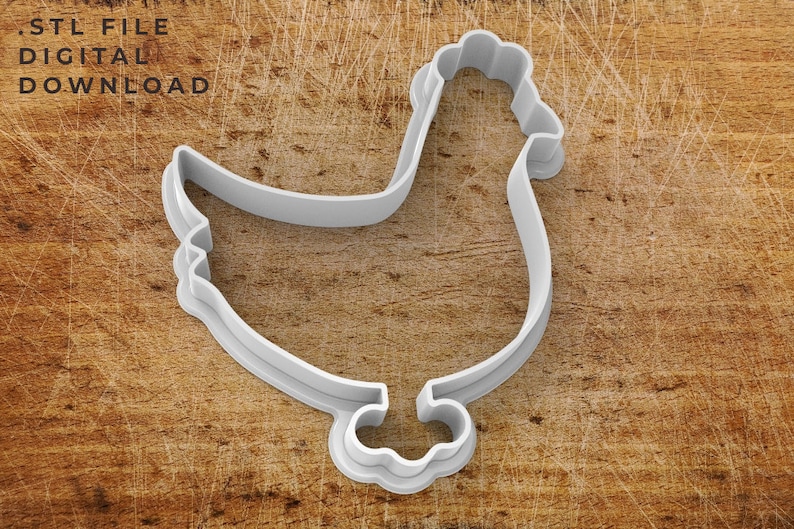 May include: A white plastic chicken-shaped cookie cutter. The cutter is a single piece with a detailed outline of a chicken. The text ".STL FILE DIGITAL DOWNLOAD" is in the upper left corner. The cutter is on a wooden surface.
