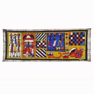 May include: A colorful batik wall hanging with a geometric pattern and scenes of people carrying baskets and a house. The background is a yellow, orange, and blue color scheme.