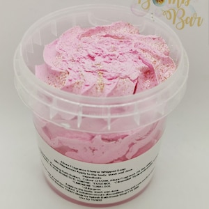 May include: A pink whipped shower soap in a clear plastic container with a white label. The label reads "Allure Fragrance Shower Whipped Soap, 30 grams (o) Apply to the body, wash and rinse. Ingredients: Colour CI17200, Allure Fragrance - ALPHA ISOMETHYL JONONE, EUGENOL, LIMONENE, LINALOOL. Apply to the body, wash and rinse. If irritation occurs discontinue use. 150421 Made by Splash Bath Bomb Shop FTE 000 Use by 15/4/22"
