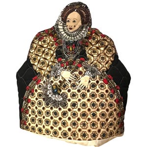 May include: A quilted tea cozy shaped like a historical figure, featuring a detailed face, elaborate ruff, and patterned gown in gold, red, and black. The cozy has a black quilted back and is designed to fit a teapot.
